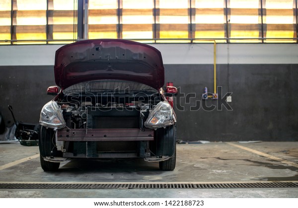 Interior of a car repair in\
garage service station with soft-focus and over light in the\
background