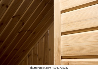 Interior carpentry background. Softwood clapboard, batten, plank timber blockhouse plank, or plank beam background with copyspace. Corner of rustic room finished with blockhouse or clapboard.