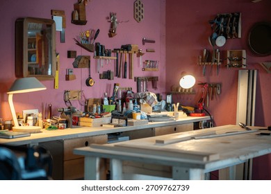 Interior of carpentry workshop with table, space filled with materials, equipment, tools hanging on wall, ideal workplace for creativity and craftsmanship, small business producing furniture items.
