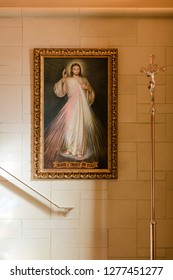 Interior of a catholic chapel with a Divine Mercy  image painting and widow light and a crucifix. Peaceful space, place of prayer. Jesus.