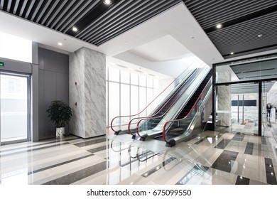 interior of center with escalator in modern office building - Powered by Shutterstock