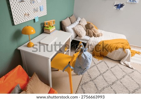 Interior of children's room with bed, study table and toys