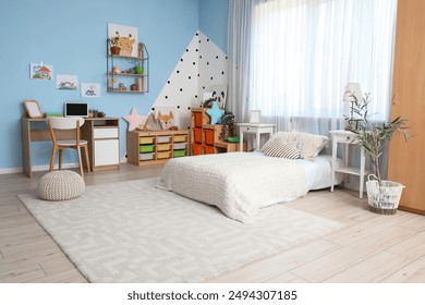 Interior of children's room with bed, tables and shelves - Powered by Shutterstock