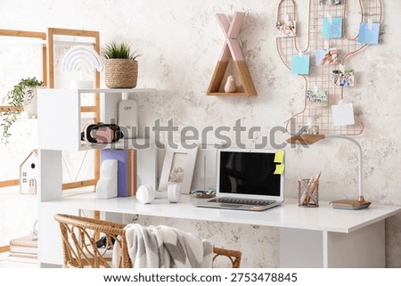 Interior of children's room with study table, pin board and shelves