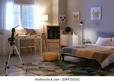 Interior of child's room with telescope in evening - Shutterstock ID 2094733162