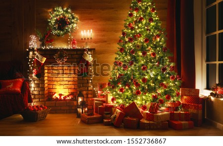 interior christmas. magic glowing tree, fireplace, gifts in  dark at night