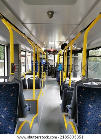Interior of a city bus. Empty bus interior. Bus with blue seats and yellow handrails. Public transport in the city of Cluj Romania