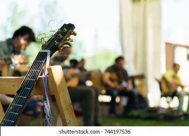 Interior of classroom with students practicing musical instruments and guitar leaned on chair.  - Powered by Shutterstock