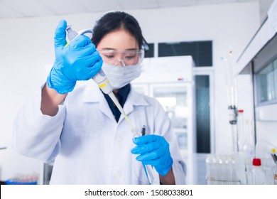 Interior Of Clean Modern White Medical Or Chemistry Laboratory Background. Laboratory Scientist Working At A Lab With Micro Pipette And Test Tubes. Laboratory Concept With Asian Woman Chemist.