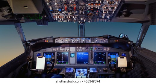 Interior of the cockpit Airplane flying above tropical sunset