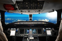 The Interior Of Cockpit Modern Business Jet, Against A Beautiful Sky, Background
