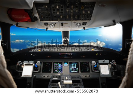 The interior of cockpit modern business jet, against a beautiful sky, background
