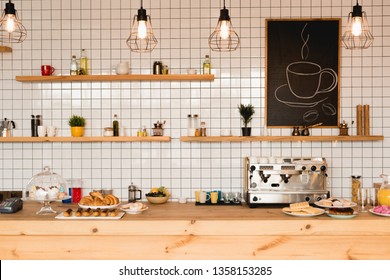 Interior Of Coffee Shop With Wooden Bar Counter, Shelves And Tiled Wall 