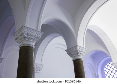 interior with columns and a vaulted ceiling
