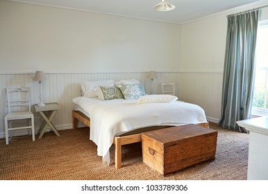 Interior of a comfortable bed in a bright master bedroom of a contemporary residential home