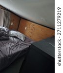 Interior of a compact tiny home, showcasing multifunctional furniture, cozy living spaces, clever storage, minimalist design, and efficient use of space in a small-scale home