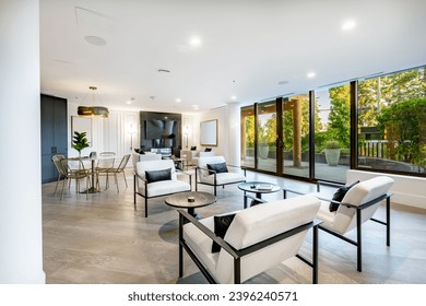 Interior of a condo building community space entry lobby concierge elevators party room kitchen theatre room public use space for apartment building with gym fireplace in the foyer