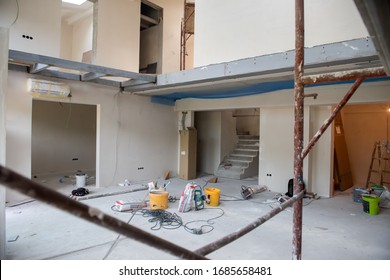 interior of construction site with scaffolding in a large modern unfinished duplex apartment - Powered by Shutterstock