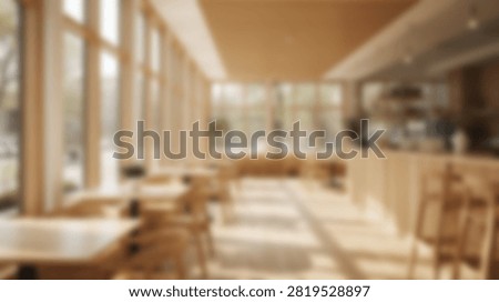 Interior of a contemporary cafe with large windows, natural light, and minimalist wooden furniture, creating a warm and inviting atmosphere.