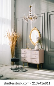 Interior of contemporary living room with dresser and vintage mirror on a wall.