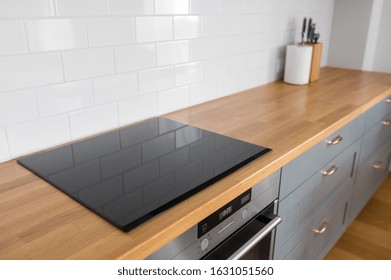 Interior And Cooking Concept - Modern Kitchen Counter With Built In Oven And Electric Hob At Home