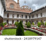 The interior courtyard of the San Luis Seminary, it characterizes the harmonious gardens with cypresses, begonias and red geraniums. the Cathedral in the background enhances the photograph.