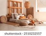 Interior of cozy bedroom with autumn decor and poufs