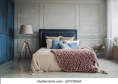 Interior of cozy bedroom in modern design with craft floor lamp