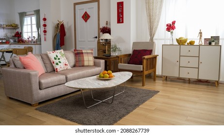 interior of a cozy bright home interior with chinese lunar new year decorations in living room and kitchen. chinese text translation: spring and congratulations everyone