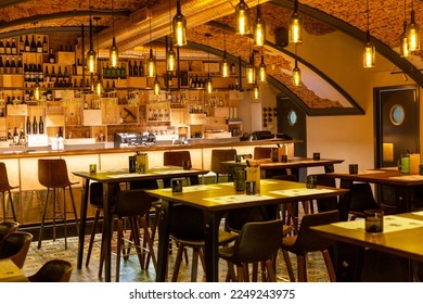 Interior of cozy modern restaurant with a bar counter and lamp lighting - Powered by Shutterstock