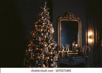 Interior Of Cozy Room Decorated In Christmas Happy New Year Style. Fireplace. No People. An Empty Sofa, Christmas Tree With Presents Under It. Selective Focus. Happy NY Mood