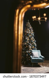 Interior Of Cozy Room Decorated In Christmas Happy New Year Style. Fireplace. No People. An Empty Sofa, Christmas Tree With Presents Under It. Selective Focus. Happy NY Mood