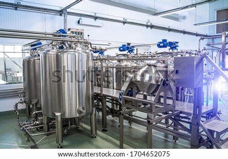 Interior of dairy factory with fermentation tank. Technology equipment at dairy farm. Sterile production.