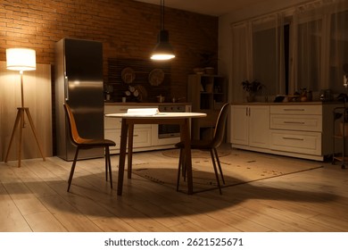 Interior of dark kitchen with counters, dining table and glowing lamps at night