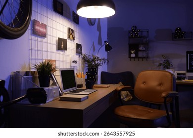 Interior of dark programmer's office with workplace, pin board and glowing lamp at night