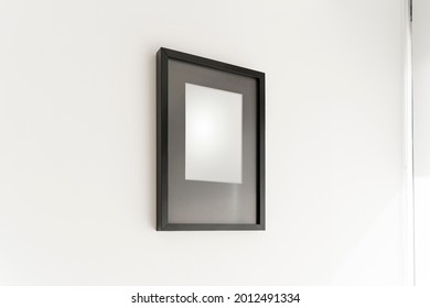 Interior Decoration, Empty Black Frame, Poster White Canvas Mock Up On A White Wall, Living Room, Template Angle View