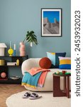 Interior desgin of modern living room interior with mock up poster frame, colorful decorations and accessories, plants, sofa, coffee table. Blue wall. Home decor. Template