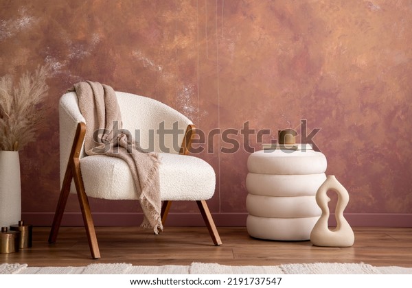 Interior design of aesthetic and elegant room with white\
boucle armchair, modern pouf, vase with dried flowers and personal\
accessories. Stylish home decor. Template. Copy space. Grunge wall.\
