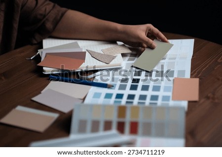 Interior design color selection process with paint and material samples on wooden table, Interior design process stock photo
