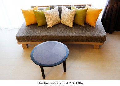 Interior design with couch, sofa with colourful designer cushions, pillows