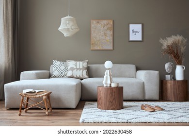 Interior design of cozy living room with stylish sofa, coffee table, dired flowers in vase, mock up poster, carpet, decoration, pillows, plaid and personal accessories in modern home decor. Template. - Shutterstock ID 2022630458