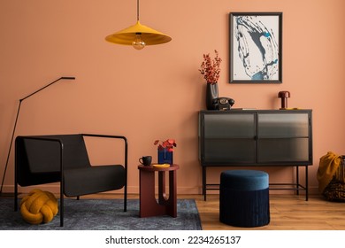 Interior design of cozy living room with mock up poster frame, glass sideboard, yellow lamp, navy pouf, carpet, black armchair, vase with dried flowers and personal accessories. Home decor. Template.