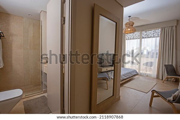 Interior\
design decor furnishing of luxury show home bedroom showing\
furniture and double bed with en suite\
bathroom