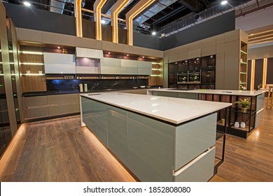 Interior design decor showing large modern kitchen with island and cupboards in luxury apartment showroom