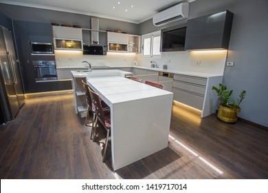 Interior design decor showing modern kitchen with cupboards in luxury apartment showroom