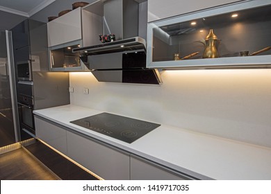 Interior design decor showing modern kitchen cooker hob appliance with extractor fan in luxury apartment showroom