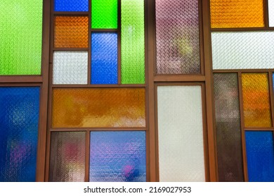 Interior design decorate wooden window and wood door with colorful stained glass background in architecture building at Wat Sangkhatan temple in Bang Phai of Nonthaburi, Thailand