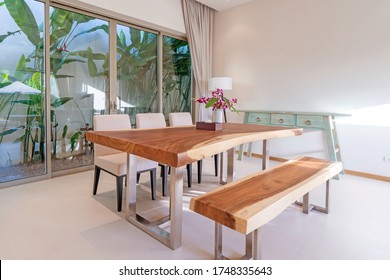 Interior Design Of Dining Area In Luxury Villa, Apartment Feature Wooden Dining Table, Bench And White Dining Chair