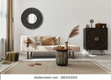 Interior design of ethnic living room with modern commode, round mirror, decoration, furniture and personal accessories. Template. White wall.