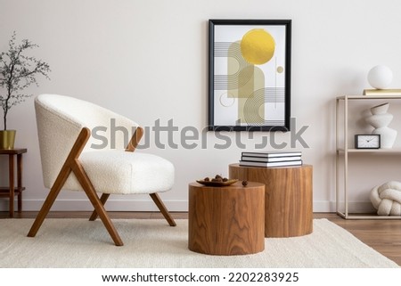 Interior design of harmonized living room with mock up poster frame, white boucle armchair, wooden coffee tables, decoration and personal accessories. Cozy home decor. Template. 
